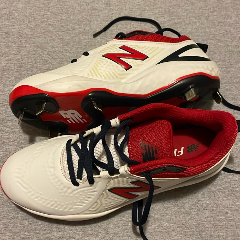 Women’s New Balance fast pitch cleats with metal cleats.